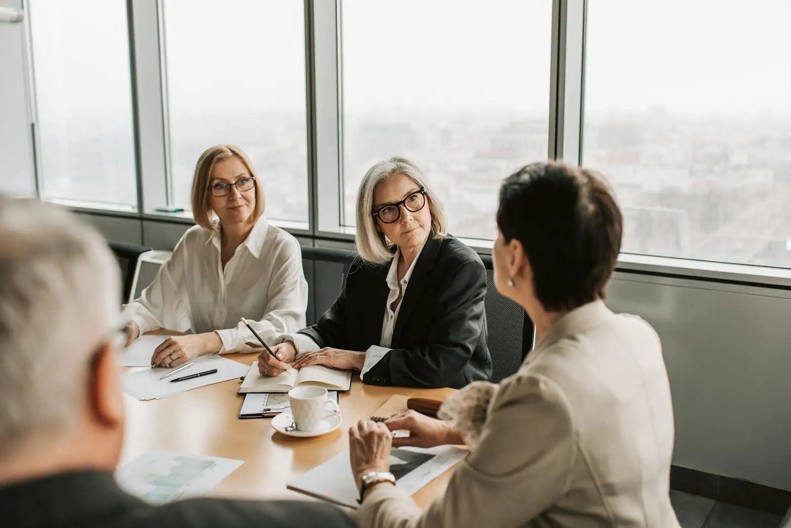 Des professionnels reunis autour d'une table examinent des documents financiers lies a un investissement en entreprise.